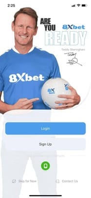 A person holding a smartphone with a webpage open displaying instructions for downloading the 8xbet application
